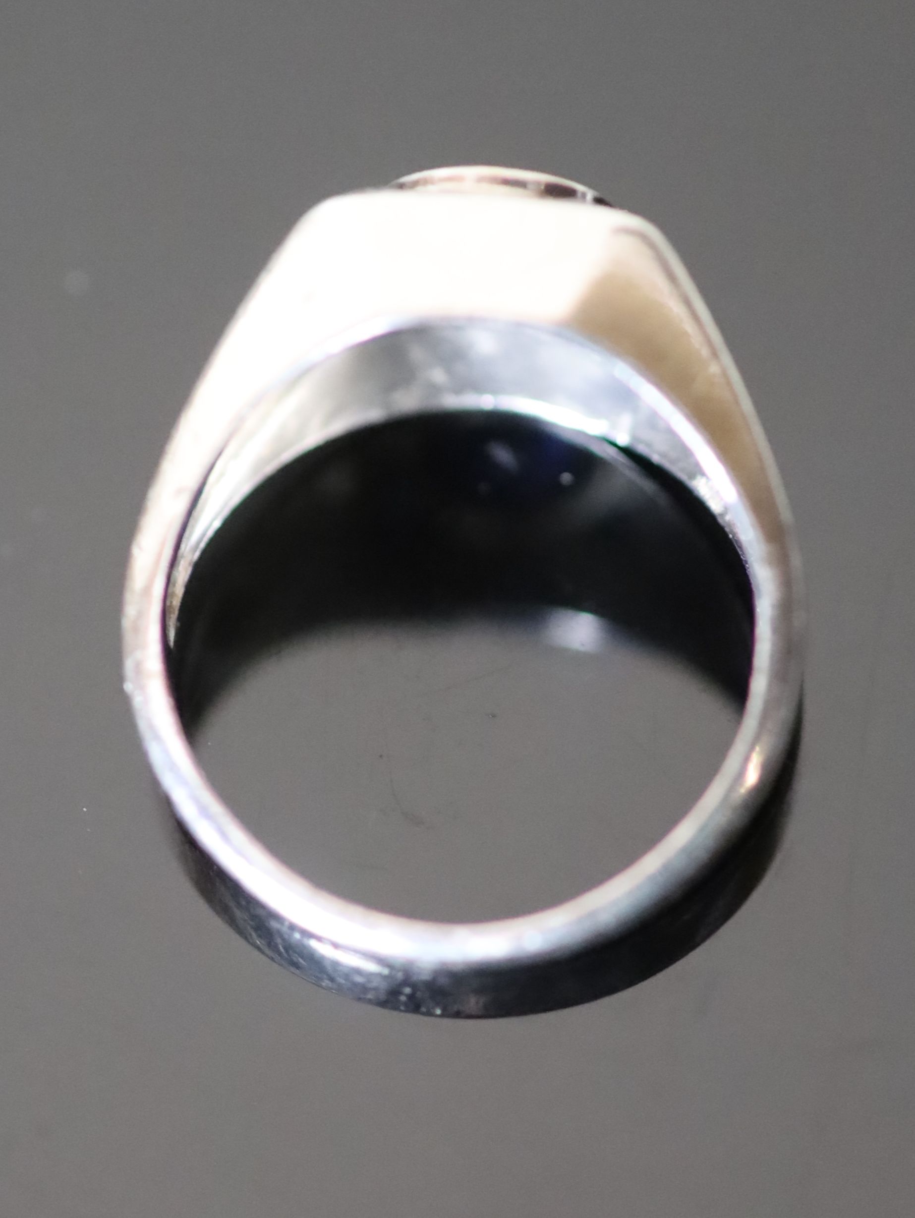 A platinum and single stone synthetic? sapphire set dress ring,